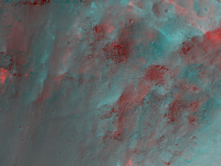 The colorful rocks exposed in the central peak visible in this image probably reflect variations in mineral content that were caused by water activity early in Mars' history.