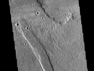 This image from NASAs Mars Odyssey shows lava flows from Alba Mons, and a tectonic graben called Cyane Fossae.