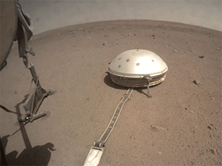 On June 28, 2019, NASA's InSight lander used its robotic arm to move the support structure for its digging instrument, informally called the "mole." This view was captured by the fisheye Instrument Context Camera under the lander's deck.