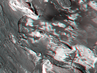 Aram Chaos is a heavily eroded impact crater that contains jumbled blocks of material disrupted when large quantities of ice or water were catastrophically removed.