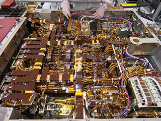 In this image, taken on June 1, 2019, an engineer in the Spacecraft Assembly Facility's High Bay 1 at NASA’s Jet Propulsion Laboratory in Pasadena, California, works on the exposed belly of the Mars 2020 rover. It has been inverted to allow the 2020 engineers and technicians easier access. 