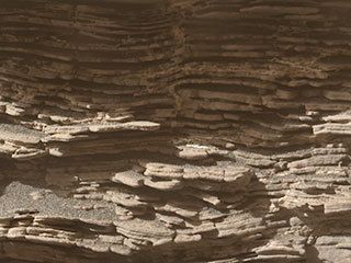 This mosaic of images shows layers of sediment on a boulder-sized rock called "Strathdon," as seen by the Mars Hand Lens Imager (MAHLI) camera carried by NASA's Curiosity rover. The images were taken on July 10, 2019, the 2,462nd Martian day, or sol, of the mission.