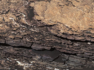 This mosaic of images shows a boulder-sized rock called "Strathdon," which is made up of many complex layers. NASA's Curiosity Mars rover took these images using its Mast Camera, or Mastcam, on July 9, 2019, the 2,461st Martian sol, or day, of the mission.