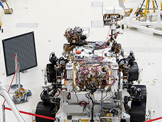 The Mars 2020 rover undergoes an "eye" exam after several cameras were installed. The rover carries everything from wide-angle landscape cameras to narrow-angle high-resolution zoom lens cameras. The image was taken on July 23, 2019, in the Spacecraft Assembly Facility's High Bay 1 at the Jet Propulsion Laboratory in Pasadena, California.