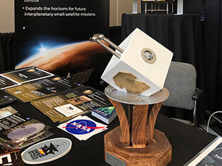 The 2019 Small Satellite Mission of the Year Award sitting at a MarCO exhibit space at the Small Satellite Conference in Logan, Utah.