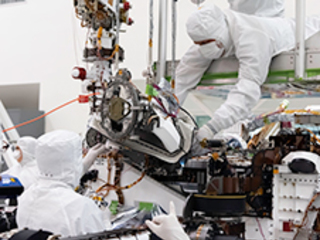 In this August 5, 2019 image, the bit carousel - the heart of sampling and caching subsystem of NASA’s Mars 2020 mission -  is attached to the front end of the rover.