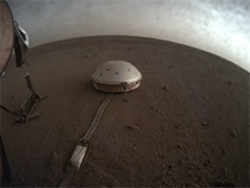 Clouds drift over the dome-covered seismometer, known as SEIS, belonging to NASA's InSight lander, on Mars.