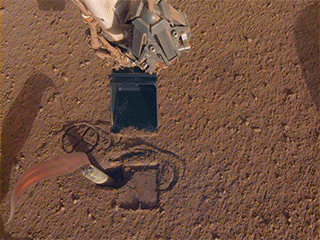 NASA InSight's robotic arm will use its scoop to pin the spacecraft's heat probe, or "mole," against the wall of its hole.
