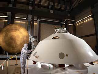 The heat shield (left) and back shell (right) that comprise the aeroshell for NASA's Mars 2020 mission are depicted in this image.