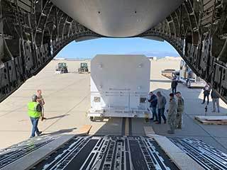​​The shipping container carrying NASA's Mars 2020 rover is readied for loading aboard an Air Force C-17 transport plane at March Air Reserve Base in Riverside, California, on Feb. 11, 2020.