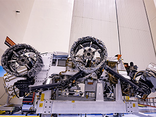 A photo of three of the six flight wheels that will travel to Mars can be seen attached to NASA's Perseverance rover 