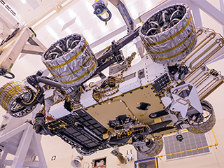 An image of the Mars Helicopter attached to the belly of NASA's Perseverance rover