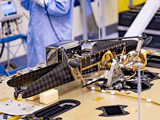 An image of the Mars Helicopter and its Mars Helicopter Delivery System attached to the Perseverance Mars rover 