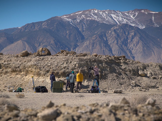A field team sets up equipment in a dry lakebed in the Nevada 