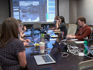 A group of scientists in a conference room