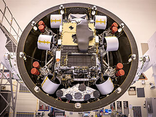 In the Payload Hazardous Servicing Facility at Kennedy Space Center in Florida, the Backshell-Powered Descent Vehicle and Entry Vehicle assemblies are being prepared to be attached to the Perseverance rover on May 4, 2020.