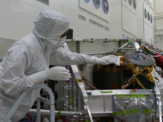 Engineer wiping down hardware to limit the number of Earth microbes going to Mars