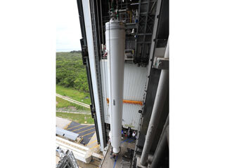 The second of four solid rocket boosters is lifted by crane