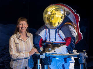 Spacesuit designer Amy Ross stands with a prototype spacesuit