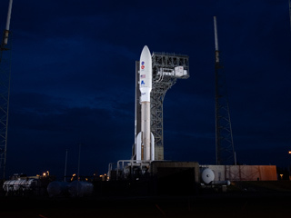 The rocket with NASA’s Mars 2020 Perseverance rover onboard is seen illuminated by spotlights on the launch pad at Space Launch Complex 41