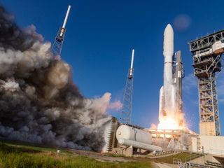The rocket carrying the Mars 2020 mission lifts off from KSC