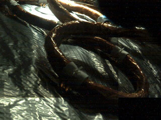 An electrical cable can be seen snaking its way along insulation material in this in-flight image of the interior of the Mars 2020 spacecraft 