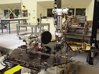 Rover 2 equipment deck, with solar arrays partially deployed, in JPL's Spacecraft Assembly Facility's cleanroom.