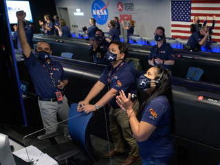 Perseverance team members eagerly watching the rover arrival on Mars