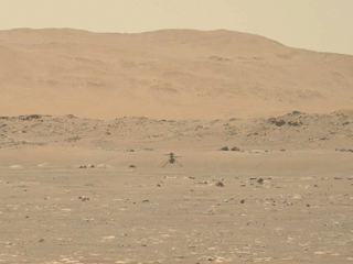 NASA’s Ingenuity Mars Helicopter hovers over the Martian surface – the first instance of powered, controlled flight on another planet – as viewed by the Mastcam-Z imager aboard the Perseverance Mars rover on April 19, 2021.