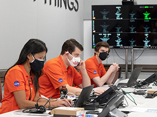 Members of NASA’s Ingenuity helicopter team in the Space Flight Operations Facility at NASA’s Jet Propulsion Laboratory prepare to receive the data downlink showing whether the helicopter completed its first flight on April 19, 2021.