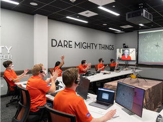 Members of NASA’s Ingenuity helicopter team react to data showing that the helicopter completed its first flight