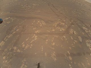 This is the first color image of the Martian surface taken by an aerial vehicle while it was aloft. The Ingenuity Mars Helicopter captured it with its color camera during its second successful flight test on April 22, 2021. At the time this image, Ingenuity was 17 feet (5.2 meters) above the surface. 