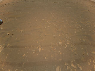 This is the third color image taken by NASA’s Ingenuity helicopter. It was snapped on the helicopter’s second flight, April 22, 2021, from an altitude of about 17 feet (5.2 meters). Tracks made by NASA’s Perseverance Mars rover can be seen as well.