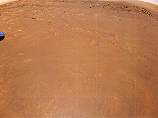 NASA’s Ingenuity Mars Helicopter took this color image during its fourth flight on April 30, 2021. “Airfield B,” it’s new landing site, can be seen below; it will seek to set down there on its fifth flight attempt.