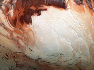 Color image whose bright white region shows the icy cap that covers Mars’ south pole, composed of frozen water and frozen carbon dioxide