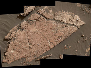 Photo displaying network of cracks on Martian rock slab called "Old Soaker" 