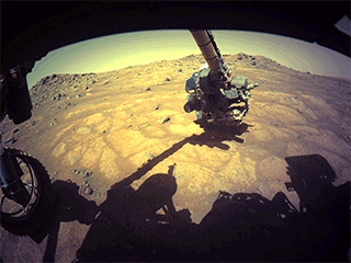 The robotic arm on NASA’s Perseverance rover reached out to examine rocks in an area on Mars nicknamed the “Cratered Floor Fractured Rough” area in this image captured on July 10, 2021 (the 138th sol, or Martian day, of its mission). 