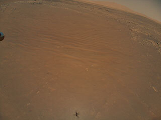 Ingenuity captured the Perseverance rover in an image taken during its 11th flight at Mars on Aug. 4.
