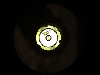 This is a colored image of Perseverance’s first cored sample of Mars rock is sealed inside its titanium container tube in this image taken by rover’s Sampling and Caching System Camera (known as CacheCam). The image was taken on Sept. 6, 2021 (the 194th sol, or Martian day, of the mission), after the seal was attached and hermetically fixed in place onto the tube. The seal’s item and serial numbers can be seen near the center of the disk. 