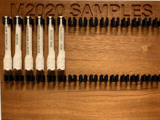 Six facsimile sample tubes hang on the sample tube board in this image taken in the offices of NASA’s Perseverance Mars rover. 