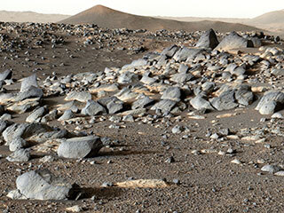 NASA’s Perseverance Mars rover looks out at an expanse of boulders on the landscape in front of a location nicknamed “Santa Cruz” on Feb. 16, 2022, the 353rd Martian day, or sol, of the mission in this panorama made of 24 images taken by the rover’s Mastcam-Z.
