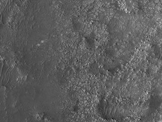 NASA’s Perseverance Mars rover and Ingenuity helicopter were spotted on the surface of the Red Planet in this black-and-white image captured Feb. 26, 2022, by the HiRISE camera aboard NASA’s Mars Reconnaissance Orbiter.