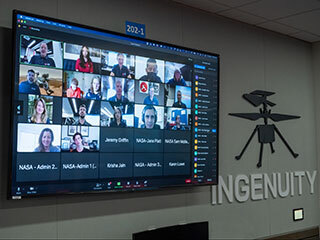 An April 5, 2022, virtual video event is seen on a monitor in the Mars Perseverance rover control room at NASA's Jet Propulsion Laboratory in Southern California.