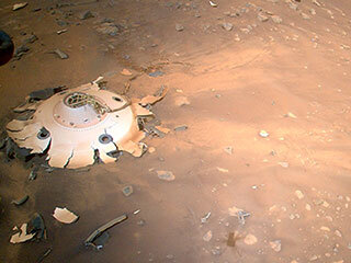 This image of the backshell and supersonic parachute of NASA’s Perseverance rover was captured by the agency’s Ingenuity Mars Helicopter during its 26th flight on Mars on April 19, 2022. 