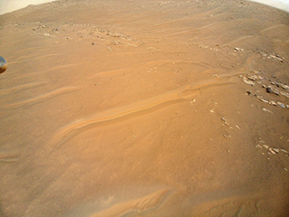 NASA’s Ingenuity Mars Helicopter scouted this ridgeline near the ancient river delta in Jezero Crater because it is of interest to Perseverance rover scientists. Enlarged at right is a close-up of one of the ridgeline’s rocky outcrops. The image was captured on April 23, during the rotorcraft’s 27th flight. 