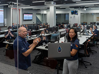 Perseverance rover team members applauded students virtually during a live video event in a mission control room at NASA's Jet Propulsion Laboratory.