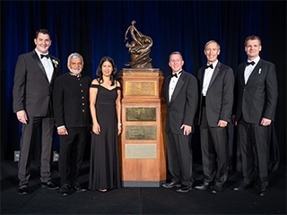 This image shows members of the Ingenuity Mars Helicopter team standing next to the NAA Collier Trophy on June 9, 2022.