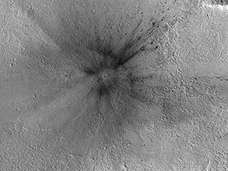 This meteoroid impact crater on Mars was discovered using the black-and-white Context Camera aboard NASA’s Mars Reconnaissance Orbiter. 