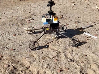A model Sample Recovery Helicopter drives and positions itself over a sample tube during a test in the Mars Yard at NASA’s Jet Propulsion Laboratory in Southern California.