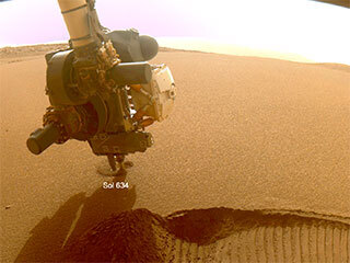 This GIF shows NASA’s Perseverance Mars rover collecting two samples of regolith – broken rock and dust – with a regolith sampling bit on the end of its robotic arm.